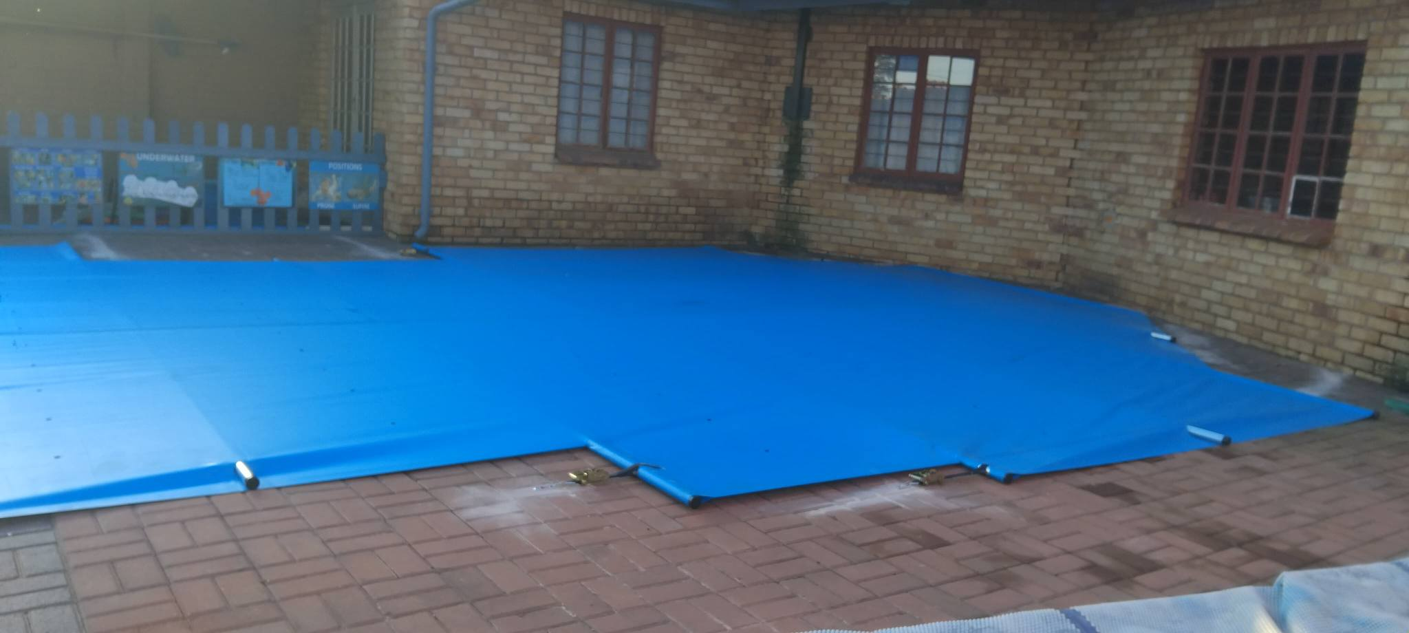 Blue PVC cover on brick paving
