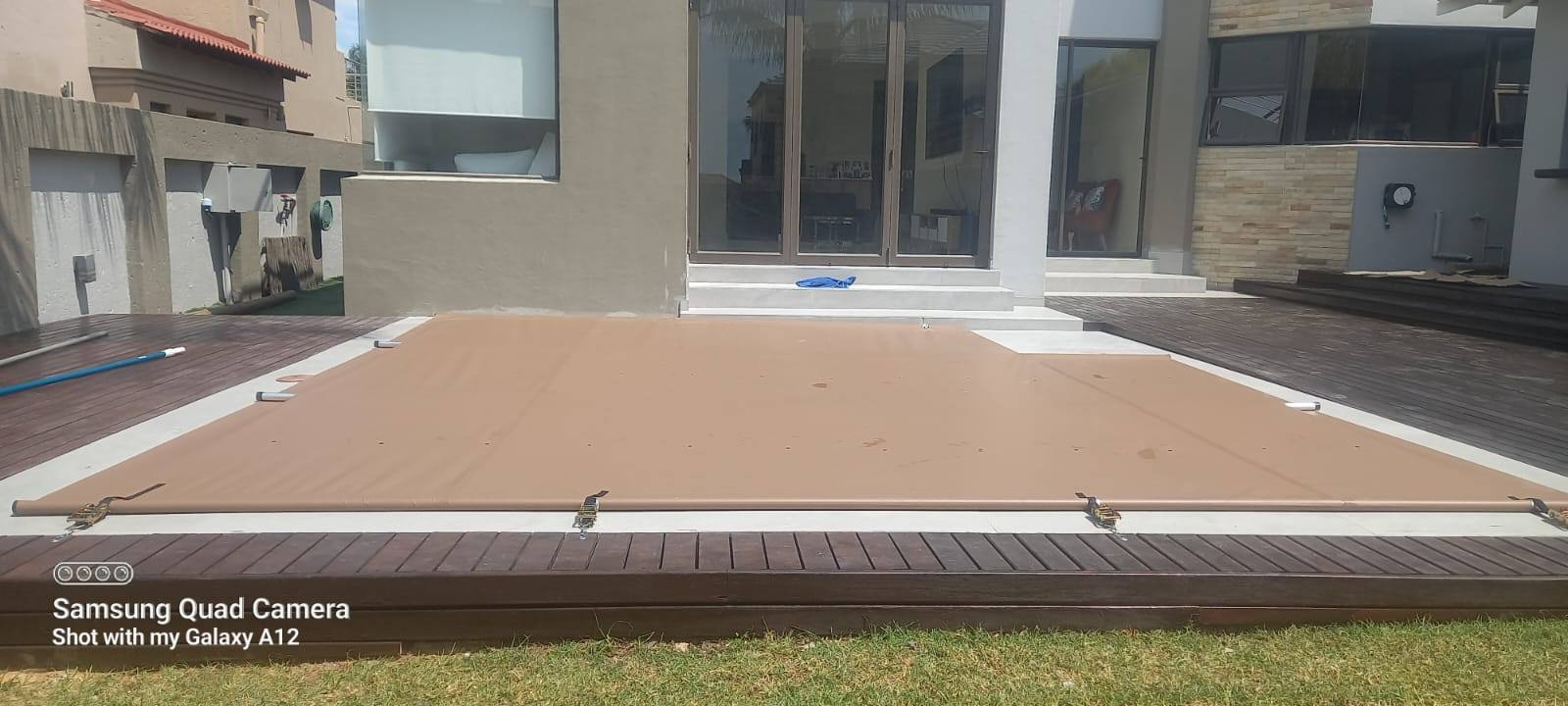 Brown PVC cover on modern deck pool